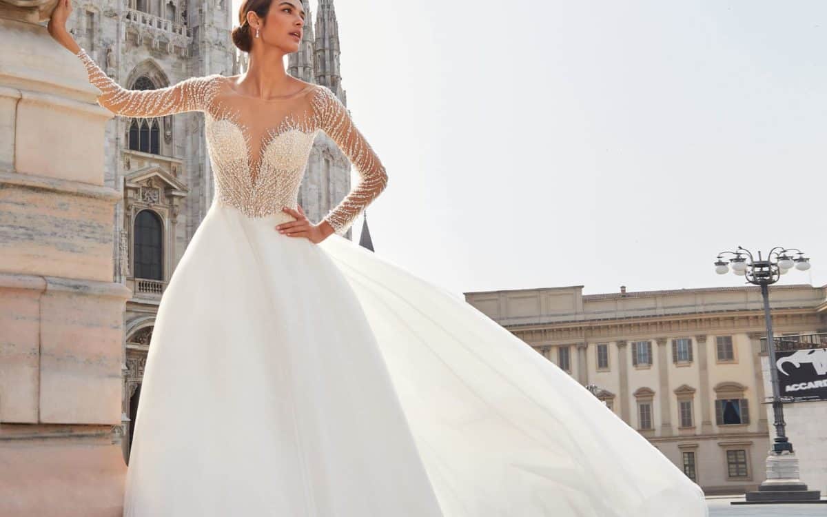 bride in her wedding dress standing in front of a church